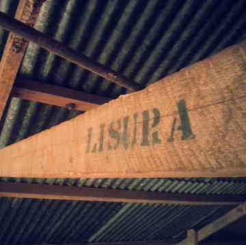 Wooden beam with original Lisura print in coffee storeroom